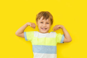 Boy smiling on yellow background