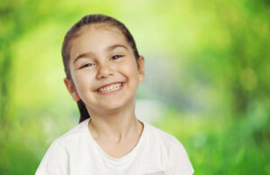 Smiling girl on green background