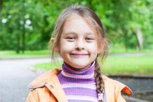 little girl with braided hair smiling